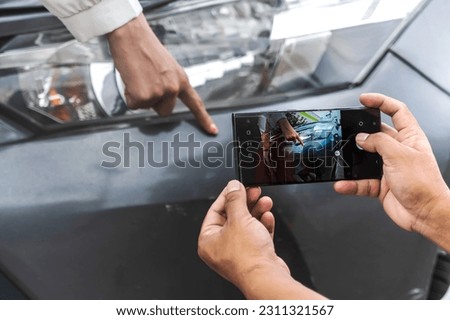 Car insurance agent man using mobile phone taking photos from car accident, car driver pointing at car damages to show insurance officer