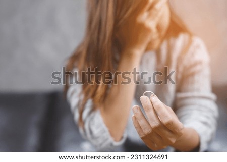 woman feeling stressed and angry, and relationships problems couple. single sad wife after divorce lamenting holding the wedding ring marry.