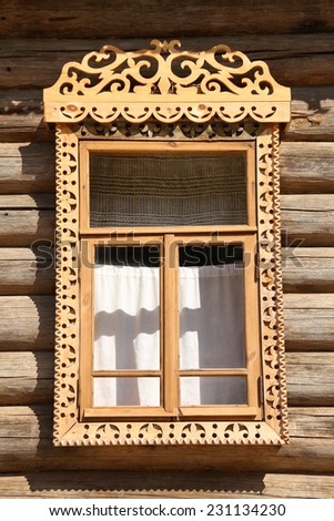 Old window of russian wooden house, a vertical picture