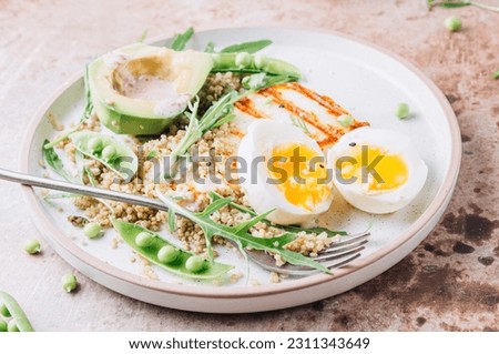 Healthy diet breakfast with grilled halloumi cheese, quinoa, egg and avocado