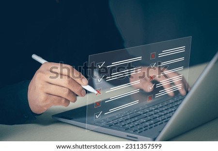 Businessman working on laptop computer productivity Document management system DMS. Assessment form, questionnaire, checklist and clipboard task management. checklist and filling survey form online.
