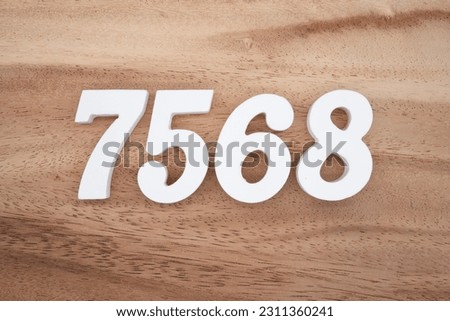 White number 7568 on a brown and light brown wooden background.