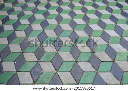 Interlocking Paver Blocks - Hexagon 3D Paver Blocks. The paving tiles of gray, black and green are lined with a geometric pattern. Background and texture