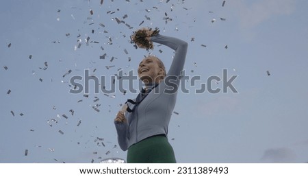 Young Female Athlete Celebrates a Win on a podium, receives a gold medal Royalty-Free Stock Photo #2311389493