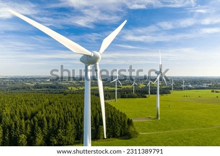 Windmills in a rural area during sunset Royalty-Free Stock Photo #2311389791