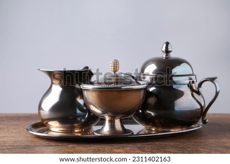 Tray with beautiful tea set on wooden table
