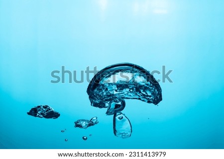 Big air bubble are rising in the blue water , air bubble isolated on blue background.