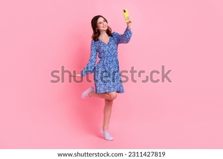Full length photo of lovely positive lady chatting speaking telephone live stream blog isolated on pink color background