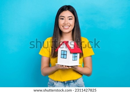 Photo of vietnamese young lady hold her new house buy insurance for rent apartment safe credit money isolated on blue color background