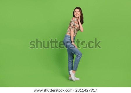 Full body photo of attractive girl posing model wear denim jeans flowers print blouse look empty space isolated on green color background