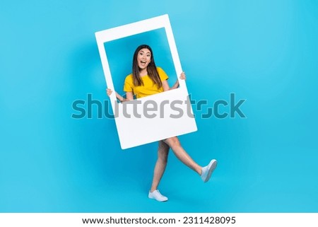 Full body photo of japanese funky young girl dancing chill carefree weekend hold frame borders capture isolated on blue color background Royalty-Free Stock Photo #2311428095