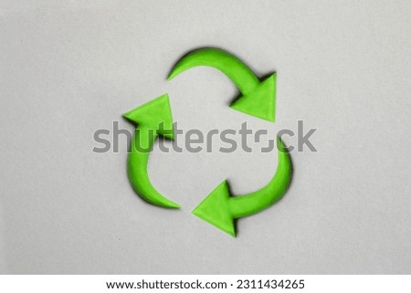 Photo of 3d recycling-Symbol made with plasticine. Sustainability concept on grey background. Green earth recycle concept.