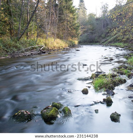mountain river with rocks and sandstones and reflections