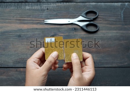 Photo illustration of a woman cutting up her credit card because she doesn't want to use it anymore                            