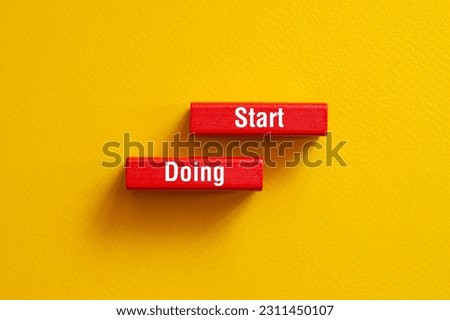 Start doing - word concept on building blocks, text, letters