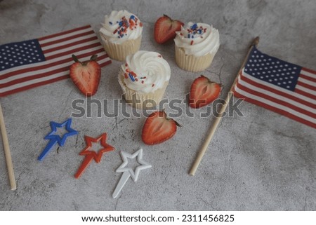 Cupcakes on the beautiful table. Healthy breakfast. Strawberry on cupcakes. American flag. Independence Day 4th of July.