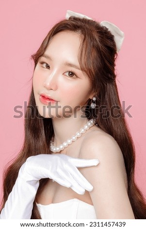 Young Asian beautiful woman Curly long hair with korean makeup style on face and perfect clear smooth skin on isolated pink background. Facial treatment, Cosmetology, plastic surgery.