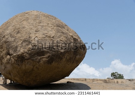 Krishna's butterball. A large boulder sitting on a slope for years without movement. Royalty-Free Stock Photo #2311461441