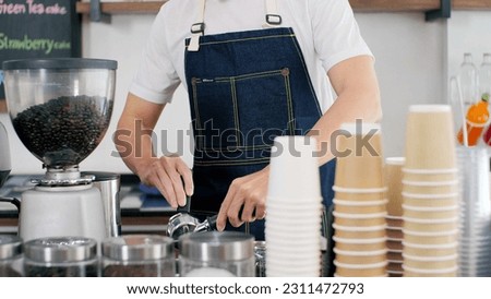 Close up hands of professional men barista in apron making coffee, latte and espresso for customer service. Coffee shop owner is preparing drinks in coffee shop, cafe