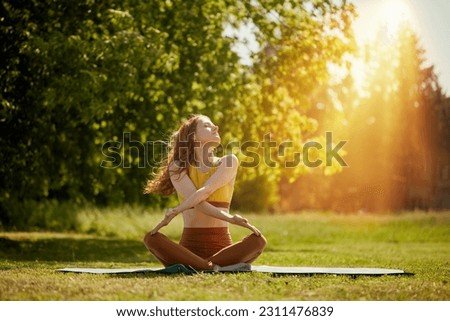 young girl doing yoga in nature, Asanas - poses in yoga for beginners Royalty-Free Stock Photo #2311476839