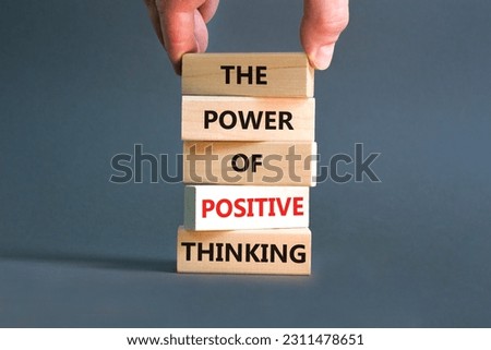 Positive thinking symbol. Concept words The power of positive thinking on wooden block. Beautiful grey background. Businessman hand. Business, motivational positive thinking concept. Copy space.