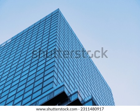 Frankfurt Germany - Low angle view of office building skyscraper next to contemporary high rise structures with glass mirrored walls and illuminated lights in Frankfurt city against cloudless blue sky Royalty-Free Stock Photo #2311480917