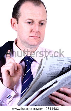 A businessman catching up on his newspaper, with his coat slung on his shoulder suggesting a slight casualness, isolated against white.