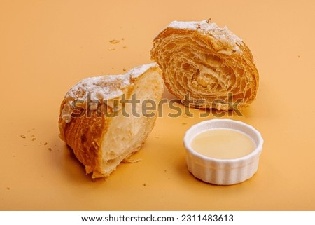 Good morning concept. Fresh croissants with cream filling and almond flakes. Sweet dessert, deconstruction, selective focus, flat lay, close up