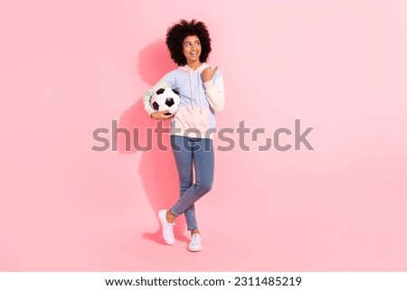 Full length photo of pretty dreamy small kid wear sweatshirt looking thumb empty space catching ball isolated pink color background