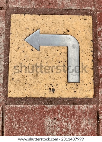 Left turn signage on sidewalk