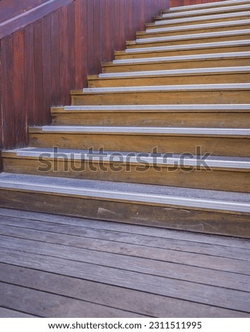 Outdoor Wooden Staircase in Tones of Red and Brown.