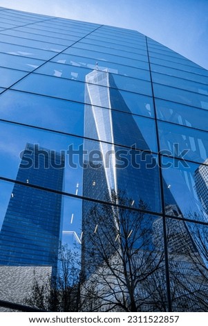 Reflection of One World Trade Center, on the glass windows of another building