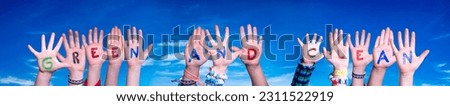 Children Hands Building Colorful English Word Green And Clean. Blue Sky As Background.