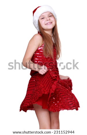 little santa girl dancing in studio on Christmas/Beautiful smiling caucasian girl on Holiday theme