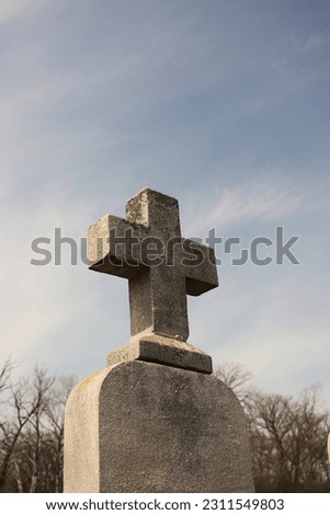 Simple and plain stone cross designating a grave in the local Christian cemetery.