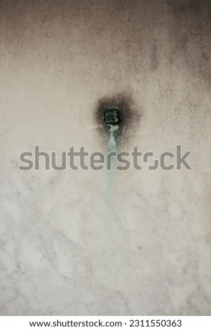A marble wall with a vintage copper joint.