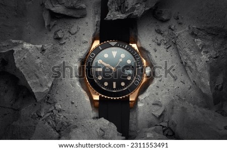 A beautiful luxury men's gold watch built into or embedded in a rock or stone. Stylish golden watch on a beautiful background of stones or rocks. Advertising photo of the watch
 Royalty-Free Stock Photo #2311553491