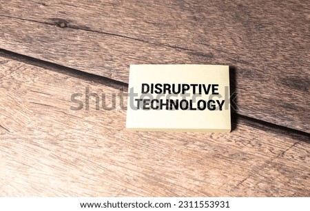 Closeup on businessman holding a card with DISRUPTIVE TECHNOLOGY message
