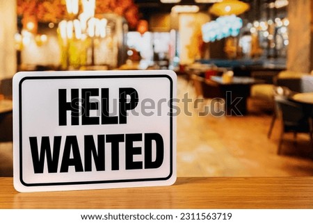 Help wanted sign inside restaurant. Food service industry jobs, labor shortage and unemployment concept. Royalty-Free Stock Photo #2311563719