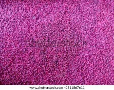 This captivating close-up photo showcases the rich texture of a red carpet, exuding an aura of opulence and sophistication. The vibrant red hue immediately draws the viewer's attention