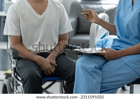 Psychologists or physiotherapists give advice and advice on health care lifestyles for male patients in wheelchairs who have pain in the genital area. and used in everyday life, health insurance. Royalty-Free Stock Photo #2311591025