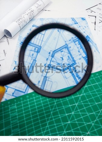 Residential building project - concept macro photography of print on paper and magnifying glass