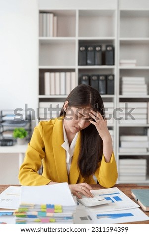 Deadline with young business woman feeling stressed concept. Business woman working at office, business finance concept Royalty-Free Stock Photo #2311594399