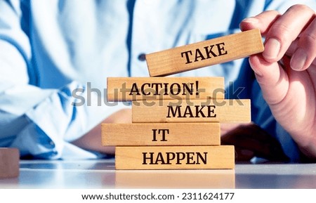 Close up on businessman holding a wooden block with a "Take action. Make it happen" message