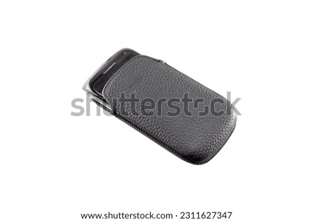 Mobile phone in a leather holster on white isolated background Royalty-Free Stock Photo #2311627347
