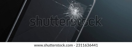 Smartphone with a broken screen on a black background. Texture of broken glass with cracks. Abstract cracked smartphone screen from shock.