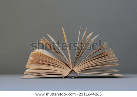 Open book on gray background education