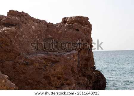 Ras Al Hadd Beach in Oman, coral reefs, mountain rocks.