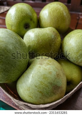 Green apples on a wooden background