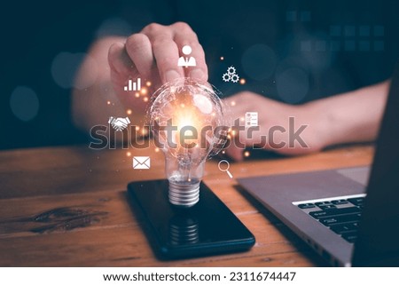 Man holding light blub on mobile with virtual Global Internet connection. Global internet connection application technology and digital marketing, Financial and banking, Digital link tech,big data